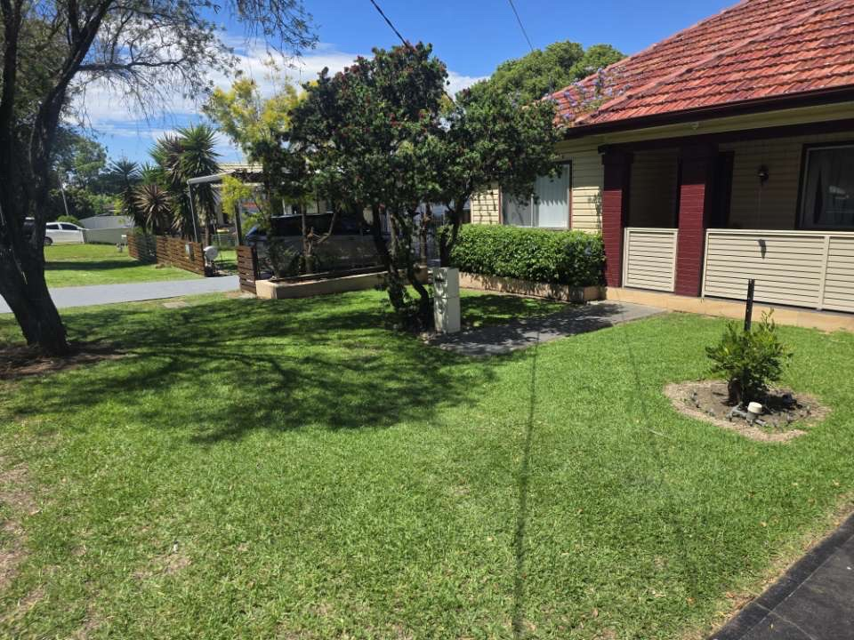 Neatly maintained front yard and garden bed